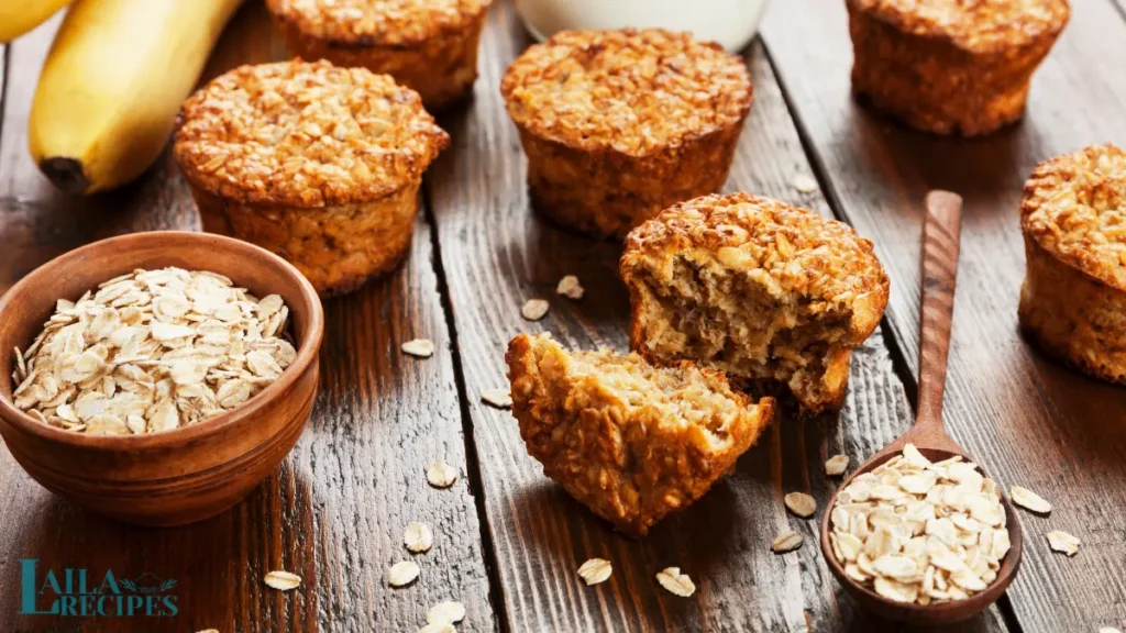 Banana oatmeal muffins served on a white plate with a drizzle of honey.