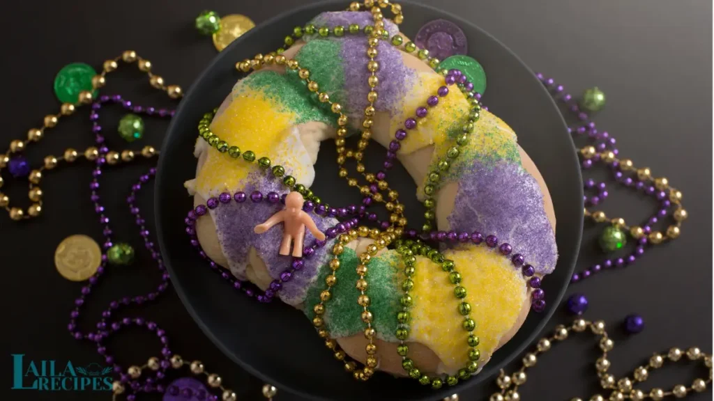 A freshly baked King Cake with vibrant purple, green, and gold icing.