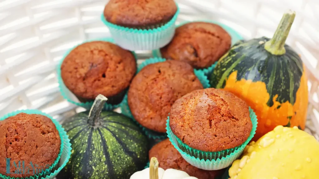 Close-up of a pumpkin muffin with a bite taken out.