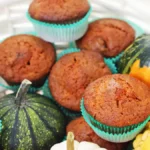 Close-up of a pumpkin muffin with a bite taken out.