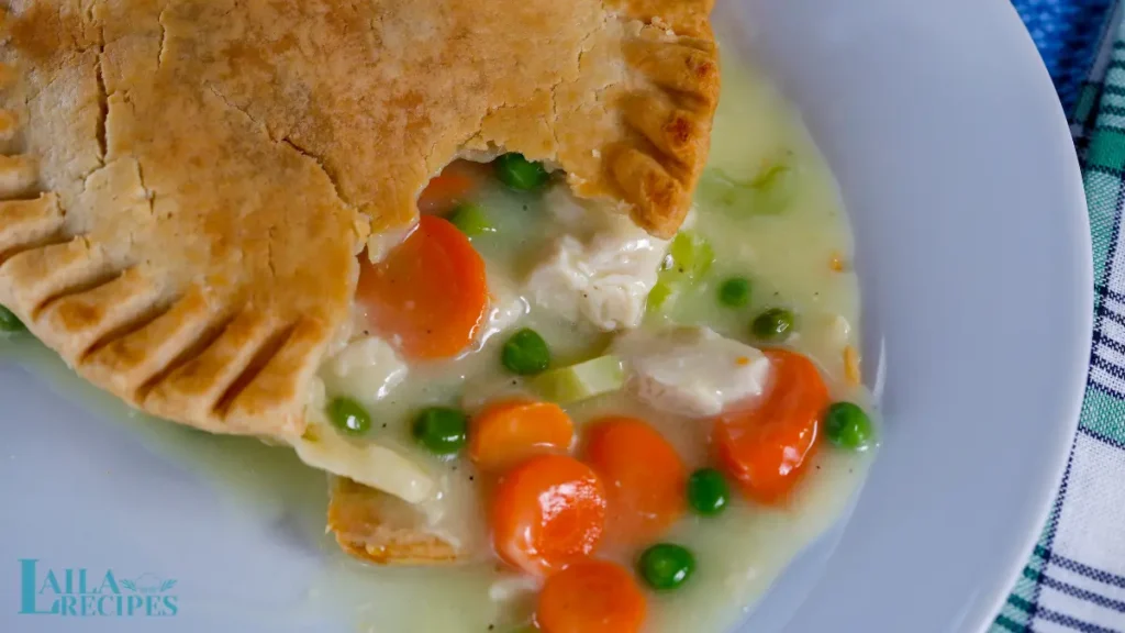 A whole pot pie cooling on a wire rack.