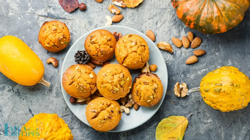 Golden brown pumpkin muffins cooling on a wire rack.