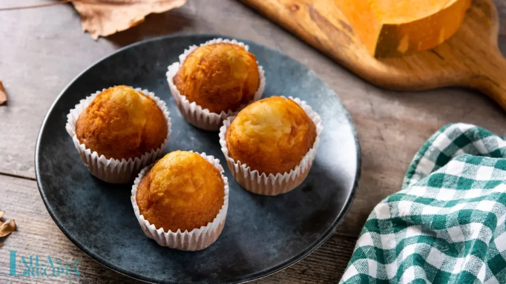 Freshly baked pumpkin muffins in a tin.